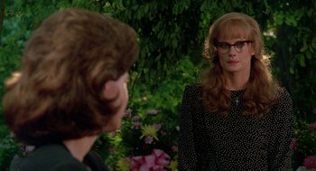 Movie still from “Steel Magnolias” (1989), directed by Herbert Ross – A woman wearing glasses and a black and white polka dot dress; Medium shot, Over the shoulder angle