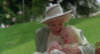 Movie still from “Steel Magnolias” (1989), directed by Herbert Ross – An older woman holding a baby in her arms; Close Up shot, High angle
