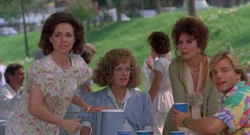 Movie still from “Steel Magnolias” (1989), directed by Herbert Ross – A group of women sitting at a table with drinks; Medium shot, Over the shoulder angle
