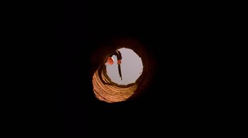 Movie still from “Breaking Bad” (2008), created by Vince Gilligan – A man is climbing up the side of a pipe; Extreme Wide shot, Low angle