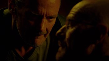 Movie still from “Breaking Bad” (2008), created by Vince Gilligan – An older man looking at the camera with a strange look on his face; Close Up shot, Over the shoulder angle