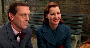 Movie still from “Stuart Little” (1999), directed by Rob Minkoff – A man and a woman sitting next to each other on a bench; Close Up shot, Over the shoulder angle