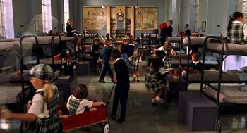 Movie still from “Stuart Little” (1999), directed by Rob Minkoff – A group of children playing with a wagon in a room; Wide shot, High angle