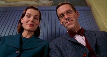 Movie still from “Stuart Little” (1999), directed by Rob Minkoff – A man and a woman posing for a picture; Close Up shot, Low angle