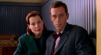 Movie still from “Stuart Little” (1999), directed by Rob Minkoff – A man and a woman posing for a picture; Close Up shot, Over the shoulder angle