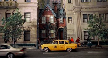 Movie still from “Stuart Little” (1999), directed by Rob Minkoff – A yellow taxi cab parked on the side of the street; Extreme Wide shot, High angle