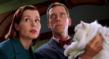 Movie still from “Stuart Little” (1999), directed by Rob Minkoff – A man and a woman holding a white cat; Close Up shot, Low angle