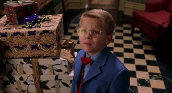 Movie still from “Stuart Little” (1999), directed by Rob Minkoff – A young boy in a suit and red tie; Close Up shot, High angle