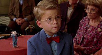 Movie still from “Stuart Little” (1999), directed by Rob Minkoff – A young boy wearing a suit and a bow tie; Close Up shot, High angle