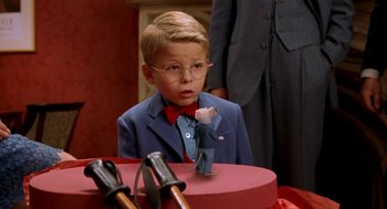 Movie still from “Stuart Little” (1999), directed by Rob Minkoff – A young boy wearing a suit and a tie; Medium shot, High angle
