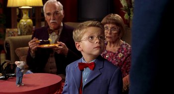 Movie still from “Stuart Little” (1999), directed by Rob Minkoff – A young boy wearing a blue suit and red bow tie; Medium shot, Over the shoulder angle