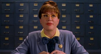 Movie still from “Stuart Little” (1999), directed by Rob Minkoff – A woman wearing a suit and bow tie; Close Up shot, Low angle