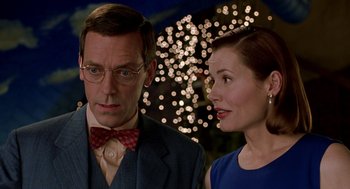 Movie still from “Stuart Little” (1999), directed by Rob Minkoff – A man and a woman standing next to each other in front of fireworks; Close Up shot, Over the shoulder angle