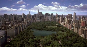 Movie still from “Stuart Little” (1999), directed by Rob Minkoff – An aerial view of a large city with trees and buildings; Extreme Wide shot, High angle