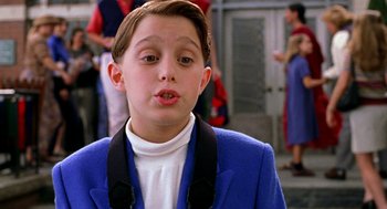Movie still from “Stuart Little” (1999), directed by Rob Minkoff – A young boy in a blue jacket and a white shirt; Close Up shot, Low angle