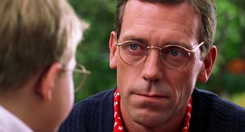 Movie still from “Stuart Little” (1999), directed by Rob Minkoff – A person wearing glasses; Close Up shot, Over the shoulder angle