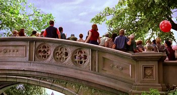 Movie still from “Stuart Little” (1999), directed by Rob Minkoff – A group of people standing on a bridge; Wide shot, High angle