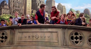 Movie still from “Stuart Little” (1999), directed by Rob Minkoff – A group of people sitting on top of a building; Wide shot, High angle