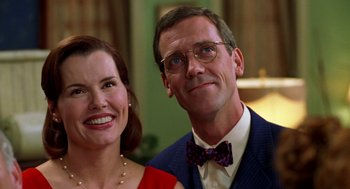 Movie still from “Stuart Little” (1999), directed by Rob Minkoff – A man and a woman posing for a picture; Close Up shot, Low angle