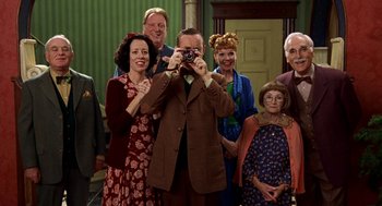 Movie still from “Stuart Little” (1999), directed by Rob Minkoff – A man taking a picture of a group of people; Medium shot, Low angle