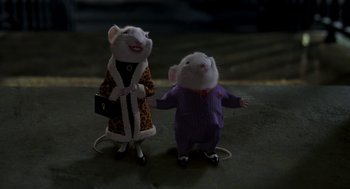 Movie still from “Stuart Little” (1999), directed by Rob Minkoff – A couple of stuffed mice standing next to each other on the ground; Medium shot, High angle