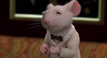 Movie still from “Stuart Little” (1999), directed by Rob Minkoff – A white mouse wearing a white suit and bow tie; Extreme Close Up shot, High angle