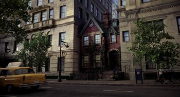 Movie still from “Stuart Little” (1999), directed by Rob Minkoff – A street scene with a building with a clock on it's side; Extreme Wide shot, High angle