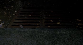 Movie still from “Stuart Little” (1999), directed by Rob Minkoff – A grate in the middle of the night; Extreme Close Up shot, Overhead angle