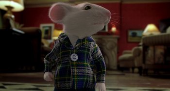 Movie still from “Stuart Little” (1999), directed by Rob Minkoff – A white mouse wearing a blue and yellow plaid shirt; Close Up shot, Over the shoulder angle