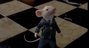 Movie still from “Stuart Little” (1999), directed by Rob Minkoff – A stuffed mouse wearing a plaid jacket and pants; Medium shot, High angle