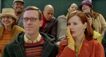 Movie still from “Stuart Little 2” (2002), directed by Rob Minkoff – A group of people that are sitting in a room; Close Up shot, Over the shoulder angle