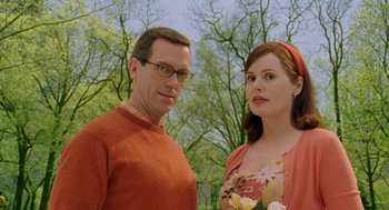 Movie still from “Stuart Little 2” (2002), directed by Rob Minkoff – A man and a woman standing next to each other in front of trees; Close Up shot, Over the shoulder angle