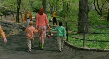 Movie still from “Stuart Little 2” (2002), directed by Rob Minkoff – A group of people walking down a path holding hands; Wide shot, Over the shoulder angle
