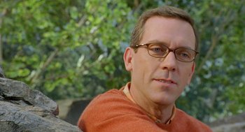Movie still from “Stuart Little 2” (2002), directed by Rob Minkoff – A person wearing glasses near a tree; Close Up shot, Over the shoulder angle
