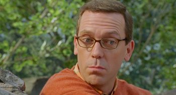 Movie still from “Stuart Little 2” (2002), directed by Rob Minkoff – A person wearing glasses with trees in the background; Close Up shot, Over the shoulder angle