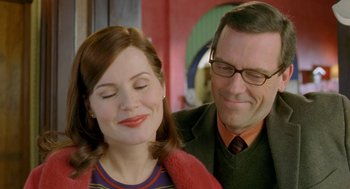 Movie still from “Stuart Little 2” (2002), directed by Rob Minkoff – A man and a woman smiling for the camera; Close Up shot, Over the shoulder angle