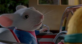 Movie still from “Stuart Little 2” (2002), directed by Rob Minkoff – A white mouse sitting in the driver's seat of a car; Close Up shot, High angle