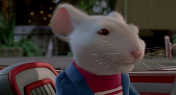 Movie still from “Stuart Little 2” (2002), directed by Rob Minkoff – A white mouse wearing a blue jacket and a pink shirt; Close Up shot, High angle
