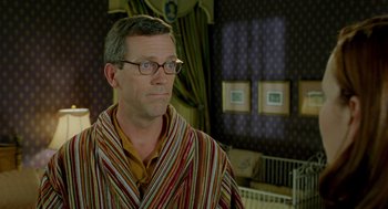 Movie still from “Stuart Little 2” (2002), directed by Rob Minkoff – A man in a striped bathrobe looking to his left; Close Up shot, Over the shoulder angle