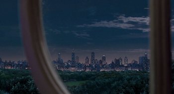 Movie still from “Stuart Little 2” (2002), directed by Rob Minkoff – A view of a city skyline at night from a window; Extreme Wide shot, Over the shoulder angle
