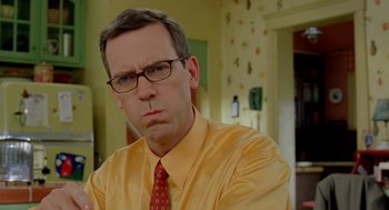 Movie still from “Stuart Little 2” (2002), directed by Rob Minkoff – A person wearing glasses and a tie; Close Up shot, Over the shoulder angle