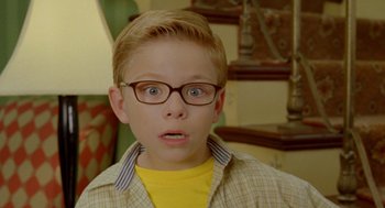 Movie still from “Stuart Little 2” (2002), directed by Rob Minkoff – A young boy wearing glasses and a yellow shirt; Close Up shot, High angle