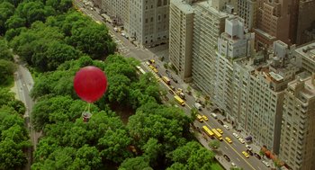 Movie still from “Stuart Little 2” (2002), directed by Rob Minkoff – An aerial view of a city with a red balloon flying over it; Extreme Wide shot, Overhead angle