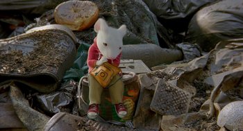 Movie still from “Stuart Little 2” (2002), directed by Rob Minkoff – A stuffed animal sitting on top of an open suitcase; Wide shot, High angle