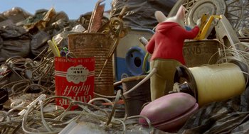 Movie still from “Stuart Little 2” (2002), directed by Rob Minkoff – An image of a person standing in a pile of trash; Wide shot, High angle