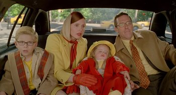 Movie still from “Stuart Little 2” (2002), directed by Rob Minkoff – A woman and a man sitting in a car with a little girl; Medium shot, Over the shoulder angle