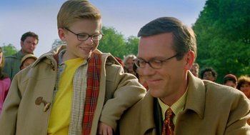 Movie still from “Stuart Little 2” (2002), directed by Rob Minkoff – A man and a boy are smiling for the camera; Medium shot, Over the shoulder angle