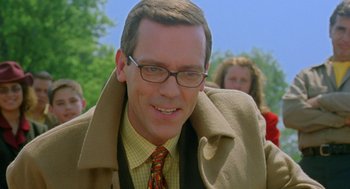 Movie still from “Stuart Little 2” (2002), directed by Rob Minkoff – A person wearing glasses and a tie; Close Up shot, Over the shoulder angle