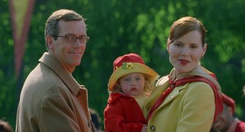 Movie still from “Stuart Little 2” (2002), directed by Rob Minkoff – A man , woman , and a little girl standing next to each other; Close Up shot, Over the shoulder angle