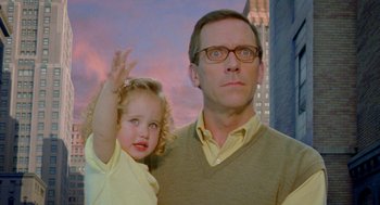 Movie still from “Stuart Little 2” (2002), directed by Rob Minkoff – A man and a little girl standing next to each other in front of a building; Medium shot, Over the shoulder angle